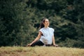 Woman in Pigeon Yoga Pose Exercising Outdoors in Nature
