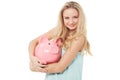 Woman, piggy bank and finance or smile in studio with cash investment, financial growth or wealth. Person, money box and Royalty Free Stock Photo