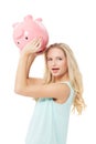 Woman, piggy bank and finance or surprised in studio with cash investment, financial growth or wealth. Person, money box