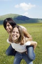 Woman Piggybacking Female Friend At Park