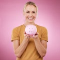 Woman, piggybank and portrait smile for savings, investment or cash money against a pink studio background. Happy female