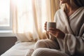 Woman in Pijama having a Cup of Hot Tea. AI Generated