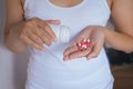 Woman with pills or capsules on hand,Pours the pills out of the bottle Royalty Free Stock Photo