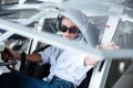 Woman pilot in headset sitting in small plane Royalty Free Stock Photo