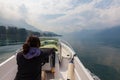 Woman piloting motor boat on a smooth, peaceful, beautiful