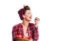 Woman, pin-up hairstyle holding basket, eating apple. Autumn harvest Royalty Free Stock Photo