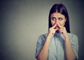 Woman pinches nose with fingers looks with disgust sideway something stinks bad smell Royalty Free Stock Photo