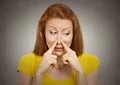 Woman pinches nose with fingers something stinks Royalty Free Stock Photo