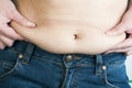 Woman pinching fat from her abdomen Royalty Free Stock Photo