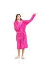 Woman in pink bathrobe pointing aside. Royalty Free Stock Photo