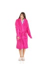 Woman in pink bathrobe pointing down. Royalty Free Stock Photo