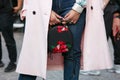 Woman with pink coat and black leather bag with red floral embroidery before Versace fashion show, Milan Royalty Free Stock Photo