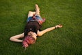 Woman with pink dreadlocks resting on the grass Royalty Free Stock Photo