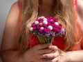 Woman in pink dress holding bridal bouquet in hands close-up. Wedding purple red white flowers bunch.Wedding decorations Royalty Free Stock Photo