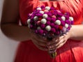 Woman in pink dress holding bridal bouquet in hands close-up. Wedding purple red white flowers bunch.Wedding decorations Royalty Free Stock Photo