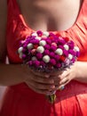 Woman in pink dress holding bridal bouquet in hands close-up. Wedding purple red white flowers bunch.Wedding decorations Royalty Free Stock Photo