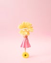 A woman in a pink dress stands on a yellow flower holding a gerbera flower in her hands Royalty Free Stock Photo