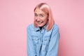 Woman with pink dyed hair smiling looking shy at camera Royalty Free Stock Photo