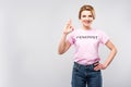 woman in pink feminist t-shirt showing ok sign