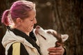 Woman with pink hair hugs Siberian Husky dog, true love of owner and pet, funny emotions