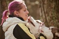 Woman with pink hair hugs Siberian Husky dog, true love of owner and pet, funny emotions