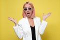 Woman with pink hair wearing white suit looking excited holding her mouth opened and hands up Royalty Free Stock Photo