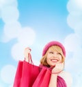 Woman in pink hat and scarf with shopping bags Royalty Free Stock Photo