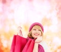 Woman in pink hat and scarf with shopping bags Royalty Free Stock Photo