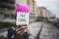 Woman with a pink hat and the text pay equal Royalty Free Stock Photo