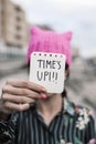 Woman with a pink hat and the text time is up