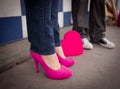 Woman with Pink Heels and Man in Black Chucks