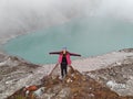 Woman in pink jacket near beautiful mountain lake