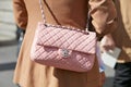 Woman with pink leather Chanel bag before Genny fashion show, Milan Fashion Week street style