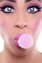 Woman With Pink Make Up Blowing Pink Bubblegum Bubble