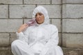 Woman in pink mask and white protective suit