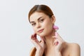 woman pink quartz roller skin care massage bare shoulders isolated background