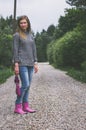 Woman in pink rubber boots with umbrella Royalty Free Stock Photo