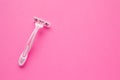 Woman pink shaver on pink background. Space for text. Disposable razor Royalty Free Stock Photo