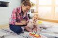 A woman in a pink shirt sits on the floor in living room and plays with her little child. Child really likes to play. Royalty Free Stock Photo