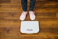 Woman with pink sneakers on bathroom weight scale Royalty Free Stock Photo