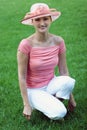 Woman in a pink straw hat