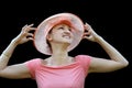 Woman in a pink straw hat