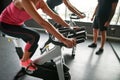 Woman in pink top exercising on stationary bike