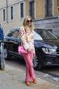 Woman with pink trousers and bag before Philosophy fashion show, Milan Fashion Week street