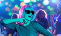 Woman in pink wig and sunglasses dancing at party