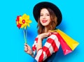 Woman with pinwheel and shopping bags Royalty Free Stock Photo