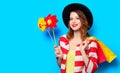 Woman with pinwheels and shopping bags Royalty Free Stock Photo