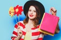 Woman with pinwheels and shopping bags Royalty Free Stock Photo