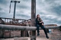 A woman pirate with a dirty face sits on a ship against a stormy sky Royalty Free Stock Photo