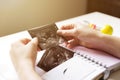 Woman placing baby`s sonogram into baby`s first year memory book